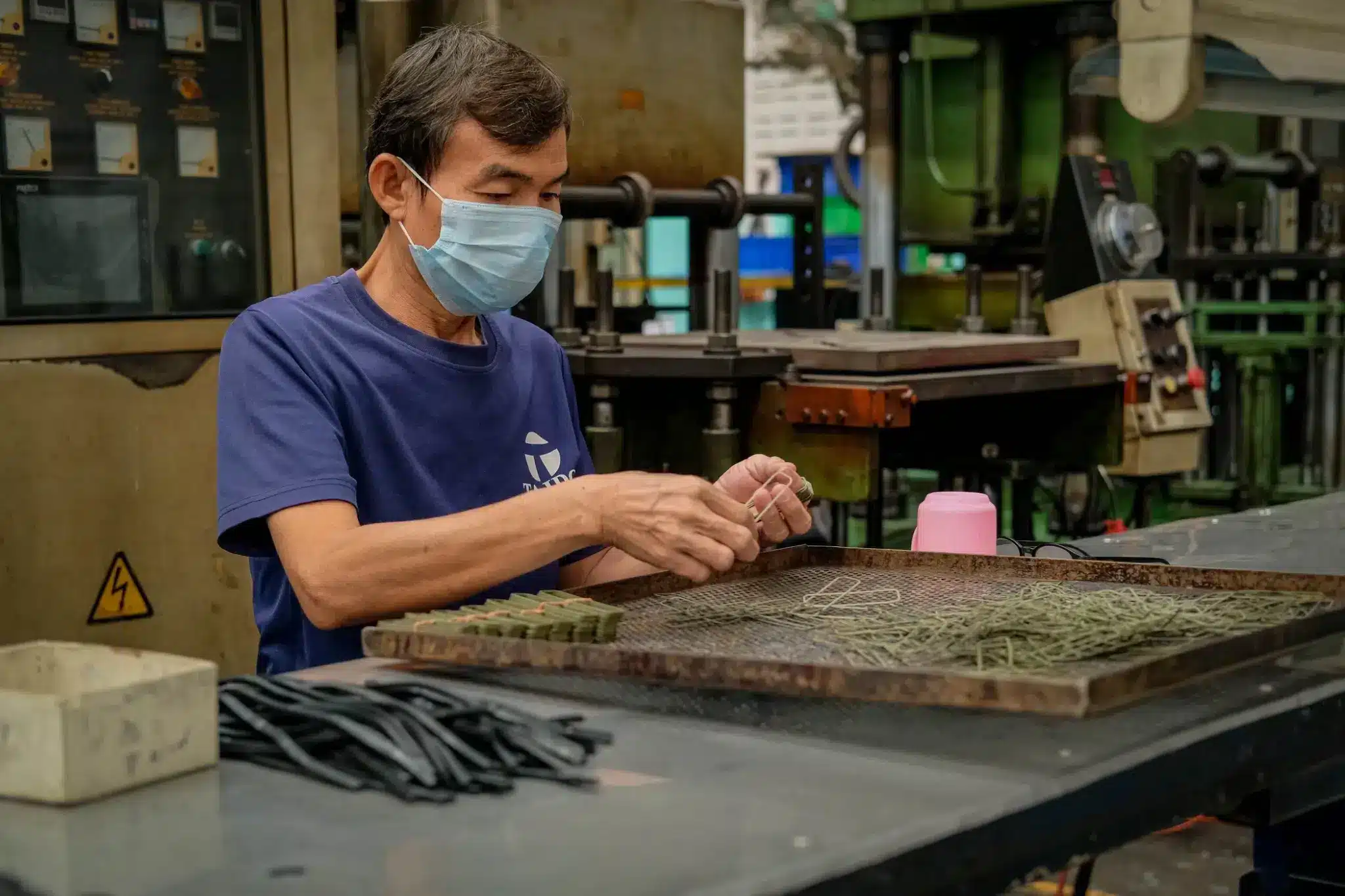 Taido technician inspecting molded rubber parts